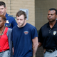 Kenneth James Gleason (center) is escorted by police to a waiting police car in Baton Rouge, La., on Sept. 19, 2017. (Gerald Herbert/AP Images)